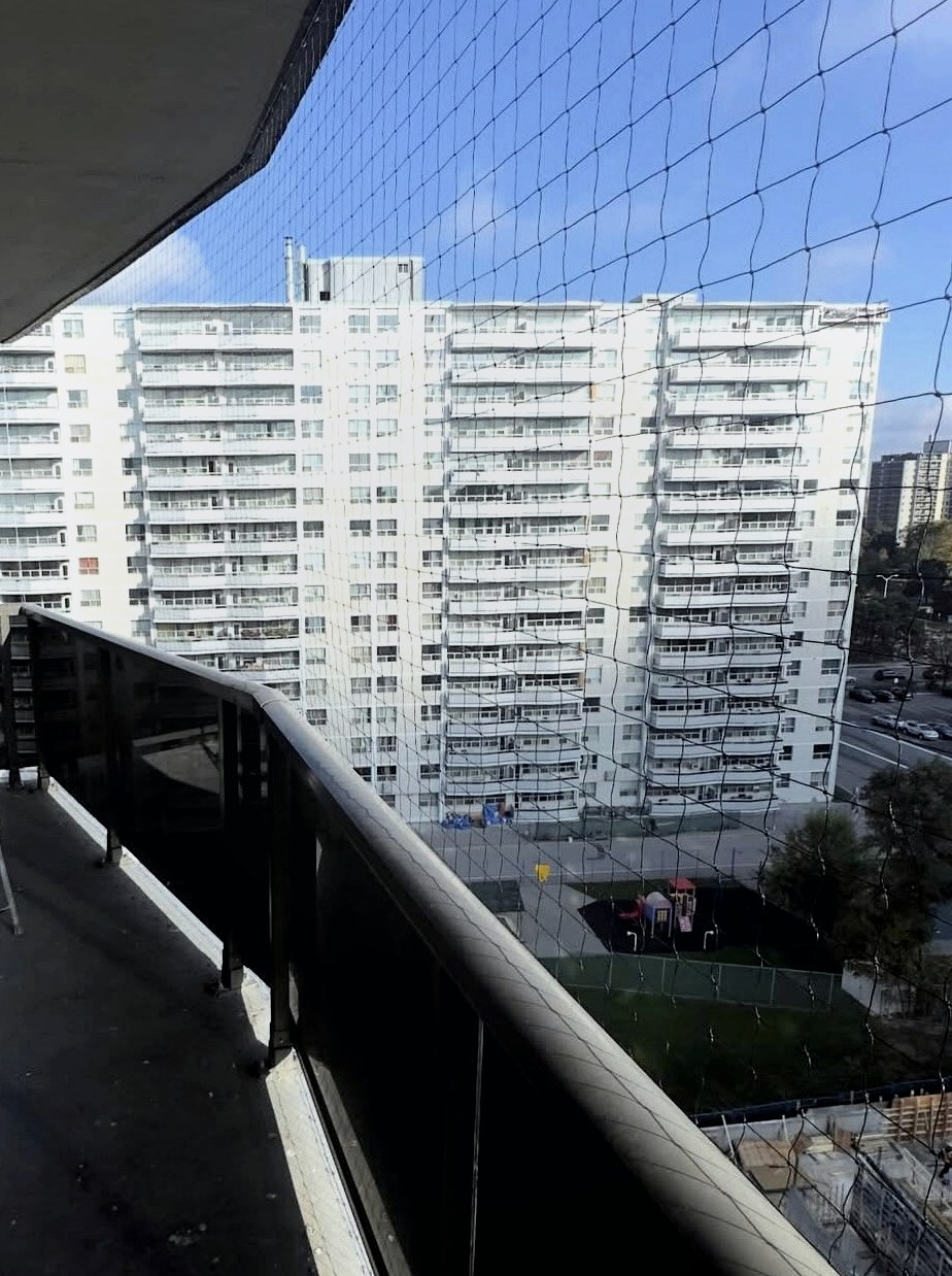 Focused balcony bird netting installation in Vancouver condo